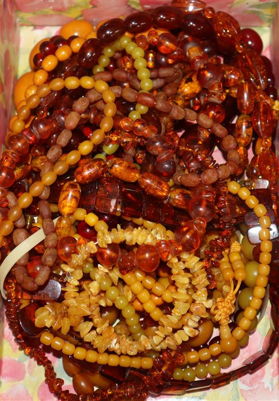 A quantity of amber and faux amber bead necklaces.